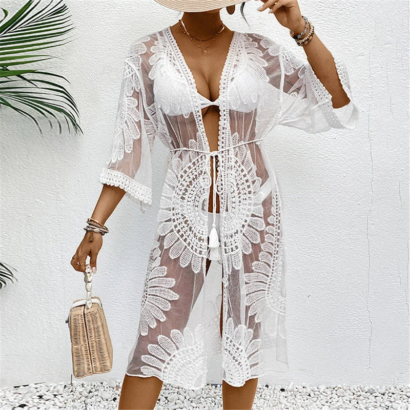 Cardigan de plage brodé en mousseline demi-manches blanc porté de face, ceinture à nouer et motifs ajourés en rosace