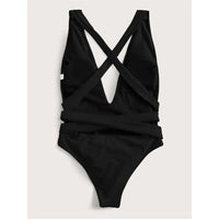 Maillot de bain une pièce triangle croisé noir posé à plat vu de dos, bretelles croisées et découpe large au centre