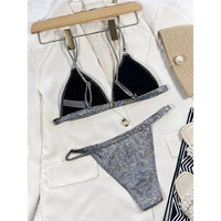 Bikini à paillettes argenté taille basse posé à plat sur une veste blanche, intérieur noir visible sous le haut