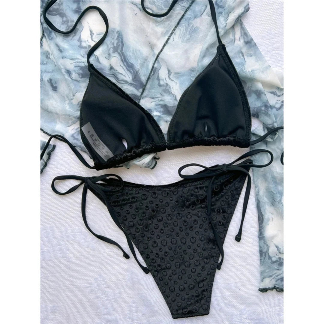 Gros plan sur le bikini tour de cou noir à motif gaufré, triangle rembourré et bas à liens latéraux