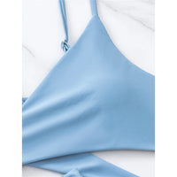 Gros plan sur le haut bleu gris sans armatures, bretelles fines réglables et bonnet lisse au décolleté en V