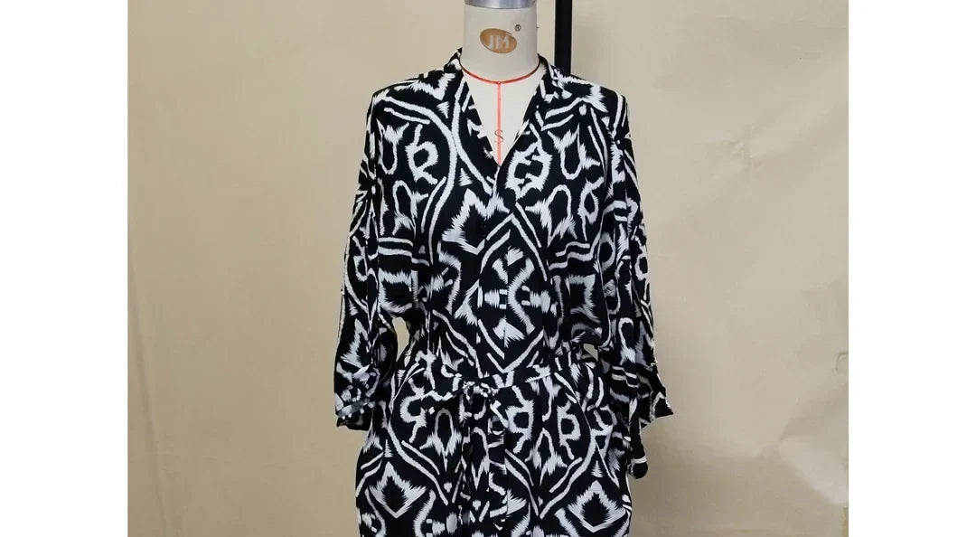 Gros plan sur le haut du kimono de plage long ceinturé imprimé graphique noir et blanc