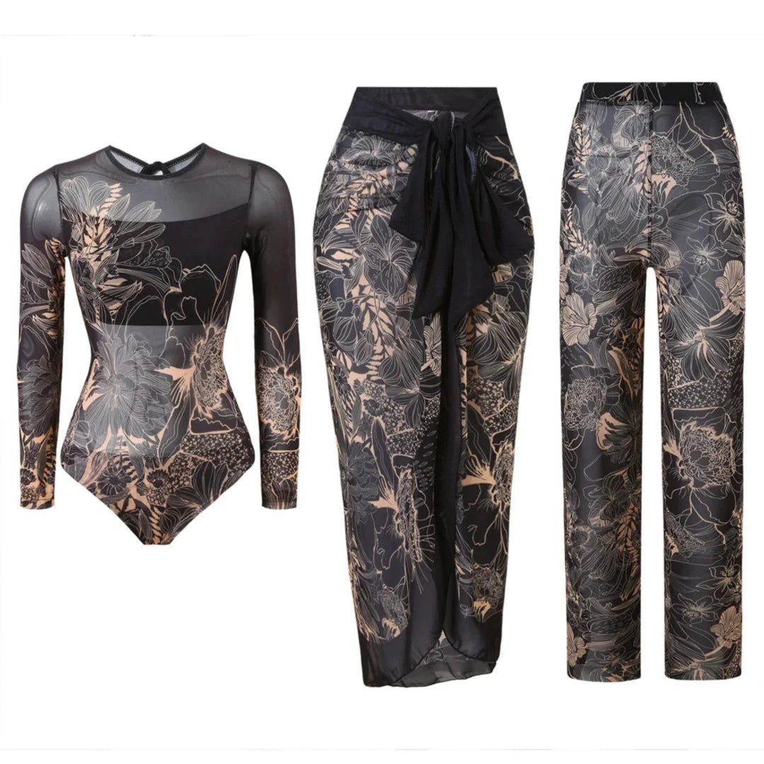 Maillot trois pièces manches longues noir à fleurs dessinées beiges, body, paréo et pantalon en mesh posés à plat