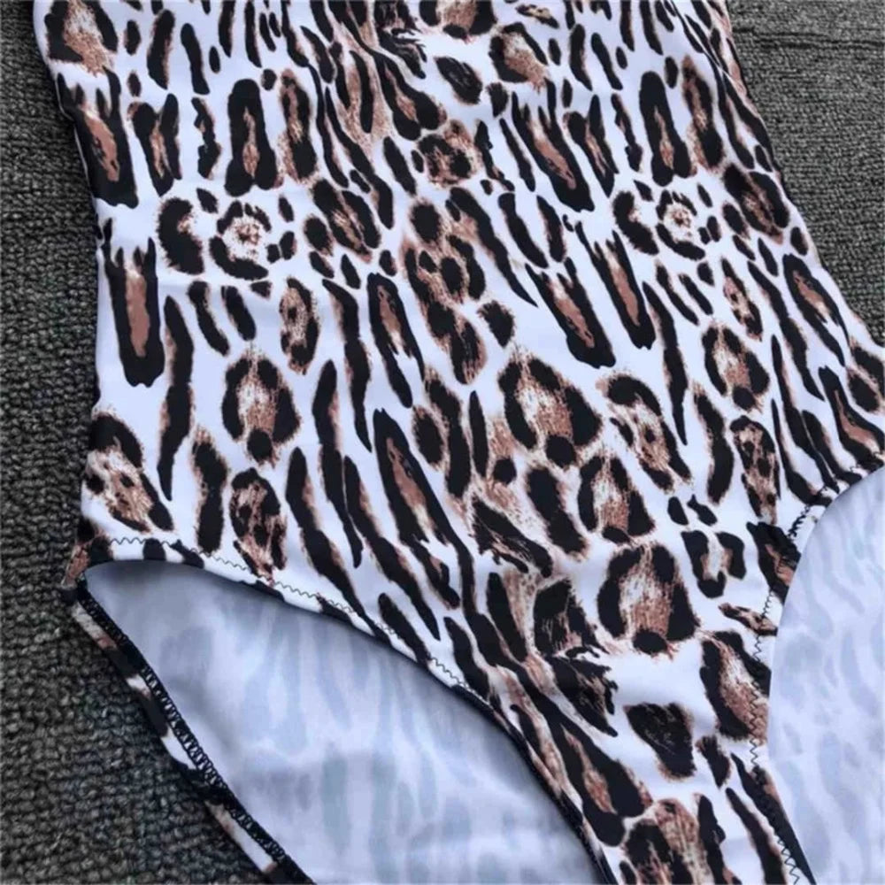 Gros plan sur le tissu imprimé léopard marron et blanc d'un maillot une pièce, entrejambe échancré