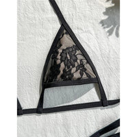 Gros plan sur le triangle en dentelle noire du bikini string micro, bordure noire et fine bretelle