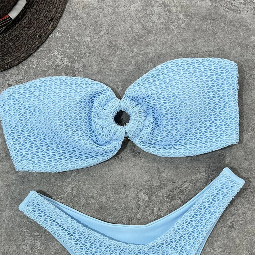 Gros plan sur le bandeau bleu clair texturé à anneau central, motif en maille ajourée et bas échancré