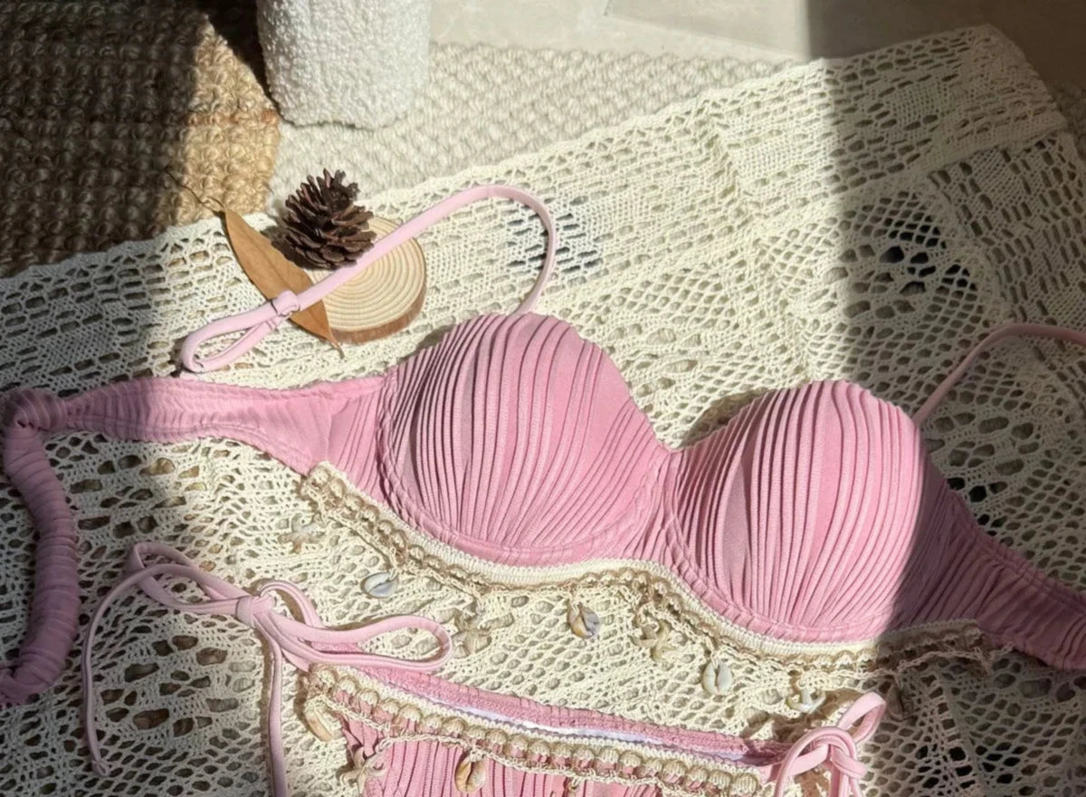 Gros plan sur le haut du bikini balconnet côtelé à armatures et coquillages rose