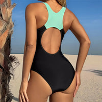 Maillot de bain une pièce dos nu échancré noir et bleu turquoise vu de dos, grande découpe ronde dans le dos