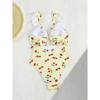 Maillot de bain une pièce à volants jaune clair à motif cerises vu de dos, bretelles à volants et lien noué au dos