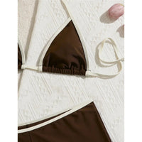 Gros plan sur le haut triangle marron café bordé de blanc et les anneaux de réglage, fond de tissu texturé